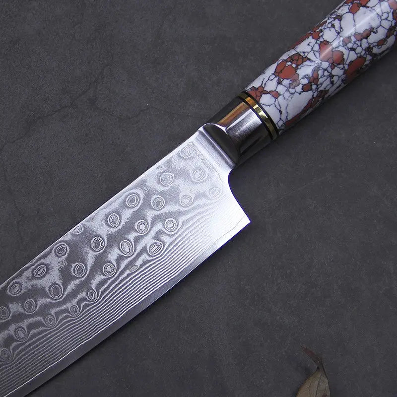 Couteau de chef en acier damas manche rouge et blanc sur fond gris