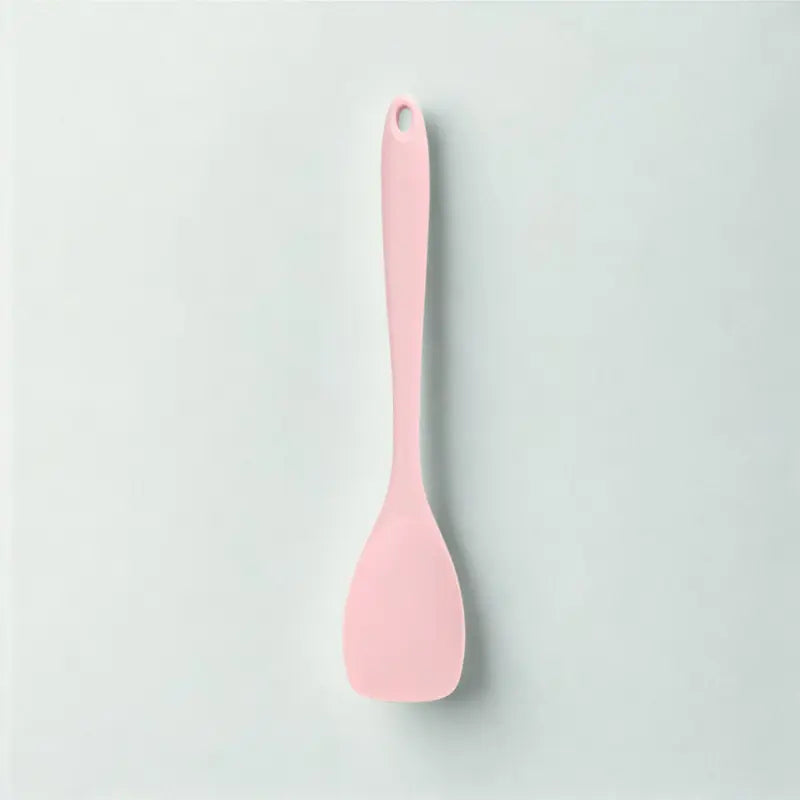 Cuillère rose sur fond blanc