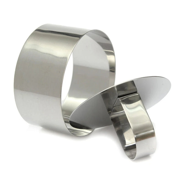 Emporte-pièce rond en acier inoxydable avec poignée à tasser sur fond blanc.
