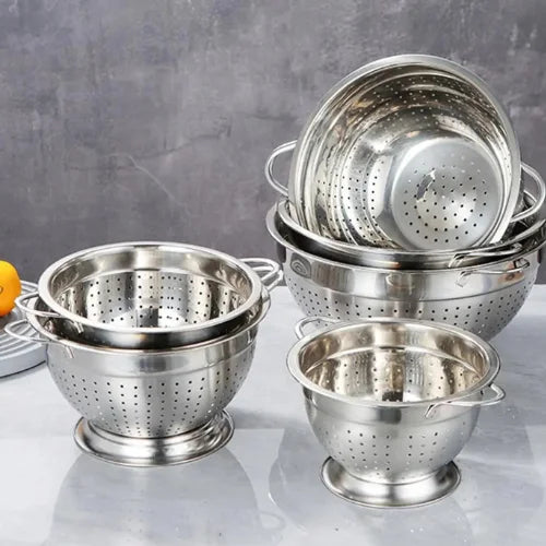 De nombreuses passoires en inox sur fond gris