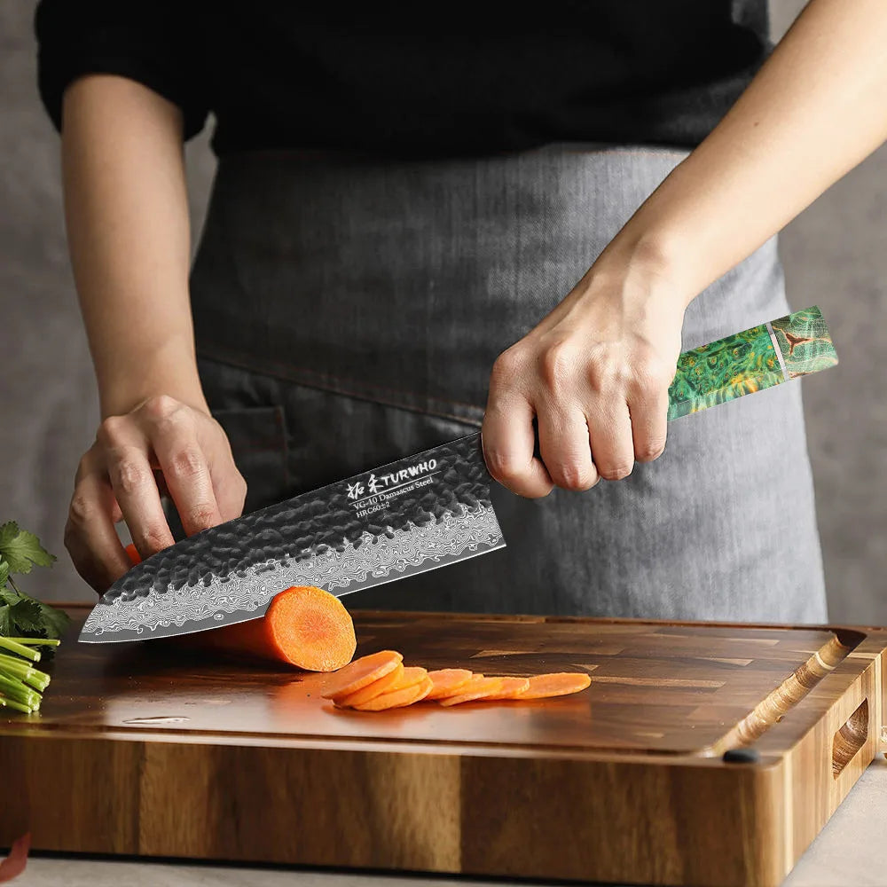 Couteau santoku en acier damas manche coloré en action.