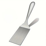 Spatule inox sur fond blanc